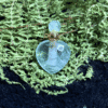 Heart-shaped crystal bottle pendant filled with prosperity intention oil – carry for abundance and wealth