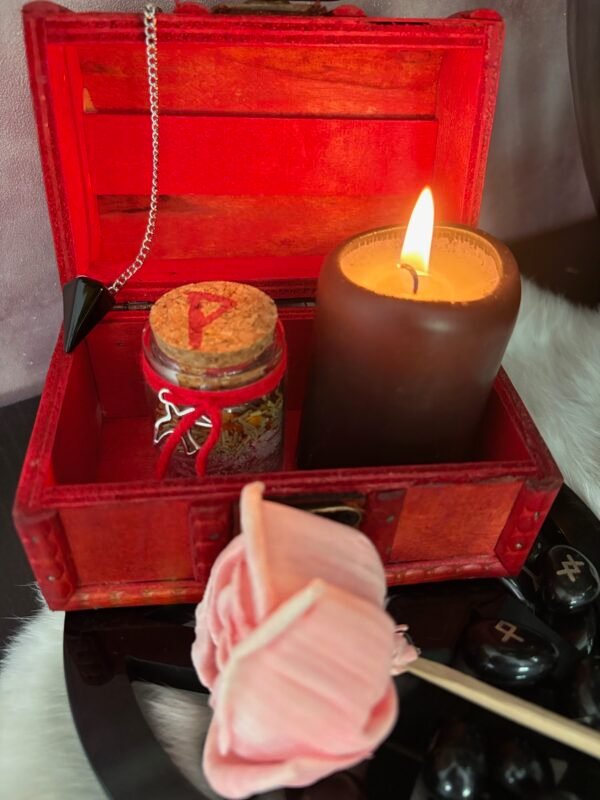 A small red wooden spell chest with vintage brass clasp, perfect for storing magical tools or using as a travel altar. Pictured open and closed, styled with runes, candle and witchy decor.