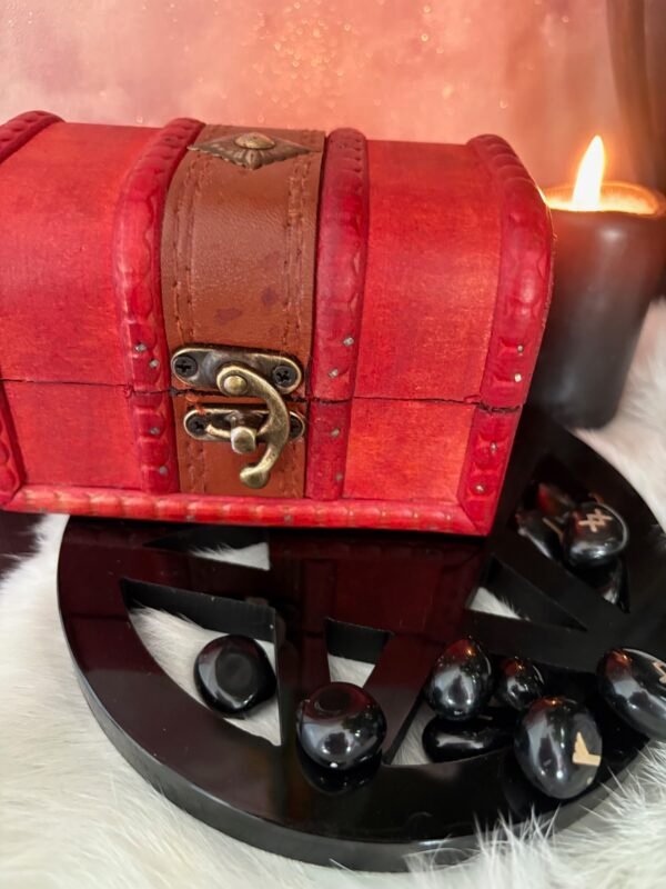 A small red wooden spell chest with vintage brass clasp, perfect for storing magical tools or using as a travel altar. Pictured open and closed, styled with runes, candle and witchy decor.