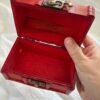 A small red wooden spell chest with vintage brass clasp, perfect for storing magical tools or using as a travel altar. Pictured open and closed, styled with runes, candle and witchy decor.