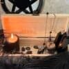 Unfinished handcrafted wooden box with metal clasp, displayed with black candle, runes, and feathers – perfect for witchcraft tools, tarot cards, or personalized altar storage.