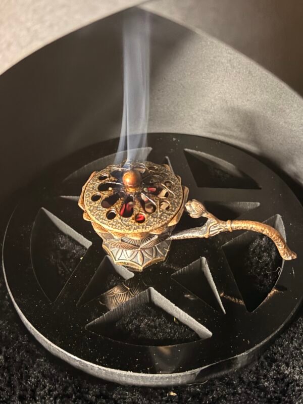 bronze incense burner with glowing charcoal and burning herbs, used for ritual and cleansing ritual pentagram