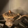 bronze incense burner with glowing charcoal and burning herbs, used for ritual and cleansing