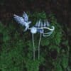 Silver hair comb with owl and forest motif resting on green moss, handcrafted nature-inspired jewelry.
