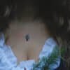 Woman wearing the silver owl pendant necklace in a forest-themed outfit, paired with a white ruffled blouse.