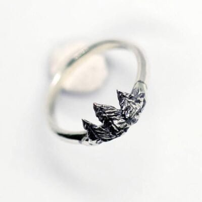 Close-up of the Diser silver ring with detailed pine tree design on a white background.
