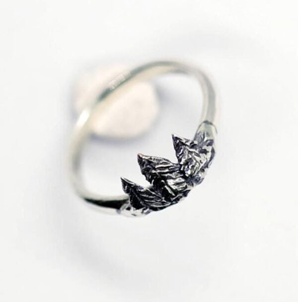 Close-up of the Diser silver ring with detailed pine tree design on a white background.