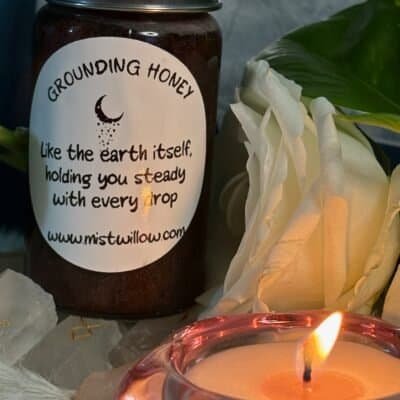 Grounding Honey jar with white rose and candle – Mistwillow ritual honey for stability and earth connection.