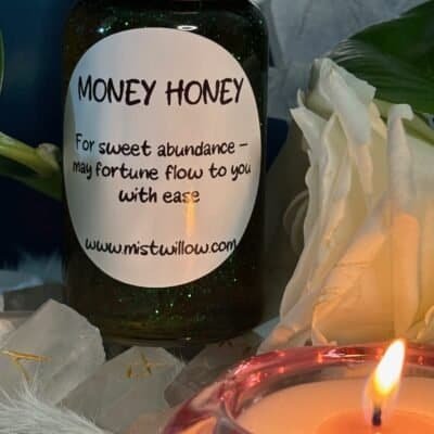 Money Honey jar with white rose and candle – Mistwillow ritual honey for abundance, prosperity, and good fortune.