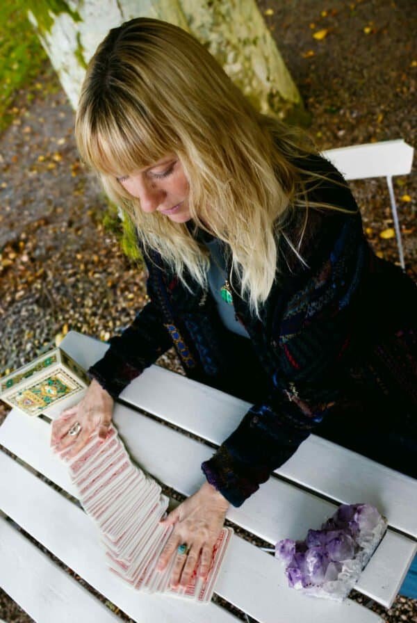 Kaelari Tarot Reading Kaelari performing a personalized tarot reading outdoors under an old tree — mystical energy, intuition and spiritual guidance.