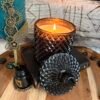 Grimoire ritual candle with flame in dark setting